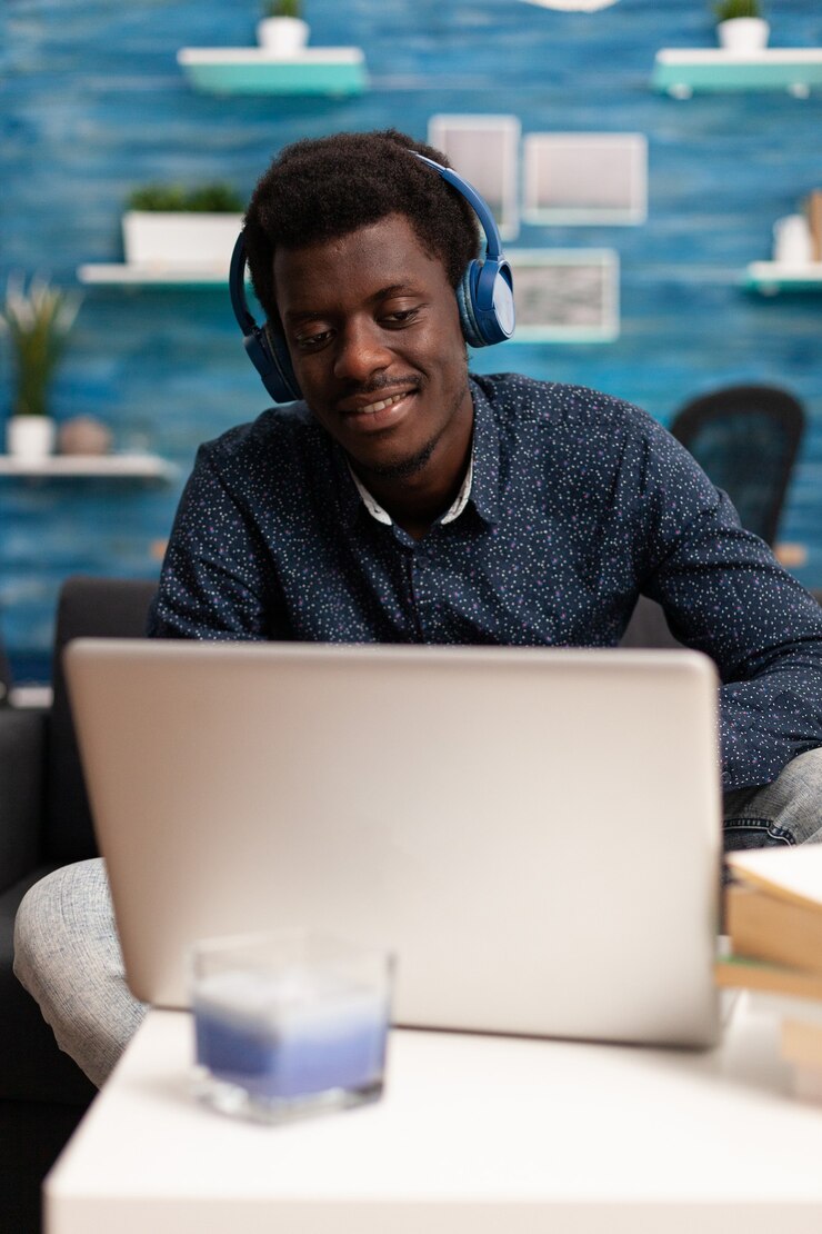 african-american-man-wearing-headphones-using-laptop_482257-7222